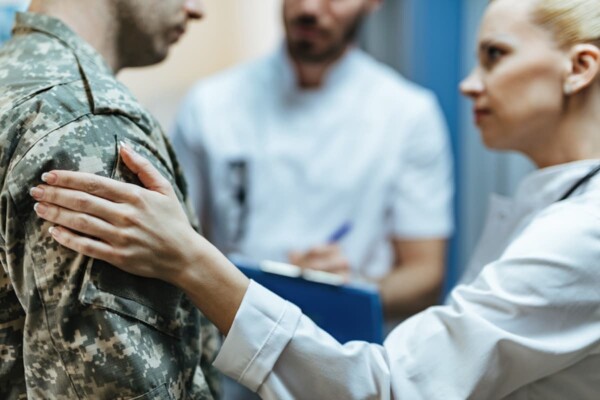 close-up-female-doctor-consoling-military-man-in-t-2023-01-06-20-07-30-utc-1-1